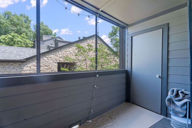 The tastefully updated screened-in balcony provides a nice outdoor area with pool views for relaxing and unwinding after a long day. | Image 24