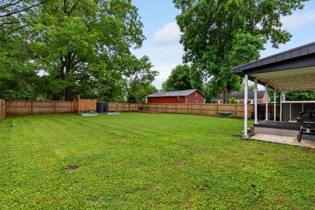 The full privacy fence combined with the single level homes and mature trees of the neighborhood make for a very private escape. | Image 6