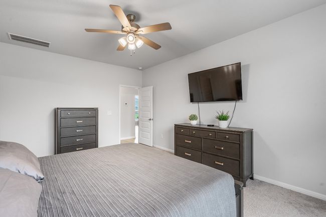 Bedroom featuring baseboards, light carpet, and ceiling fan | Image 15