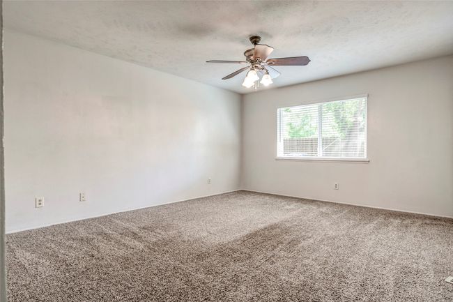 Carpeted empty room featuring a ceiling fan | Image 21
