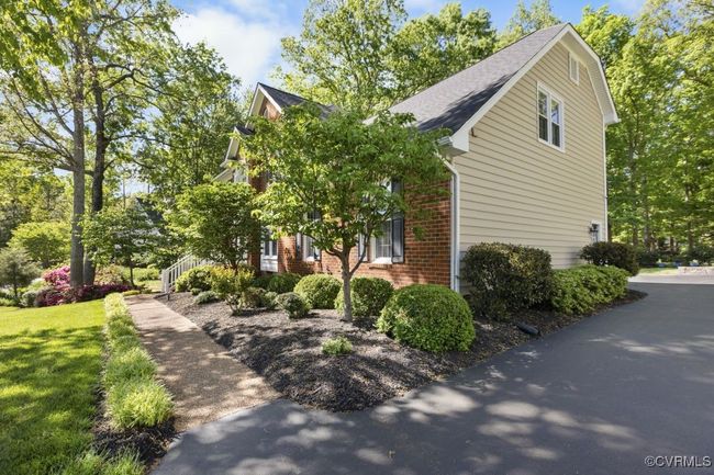 View of side of property featuring brick siding, a shingled roof, and a yard | Image 5