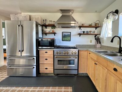 kitchen area with SS frige and range | Image 2