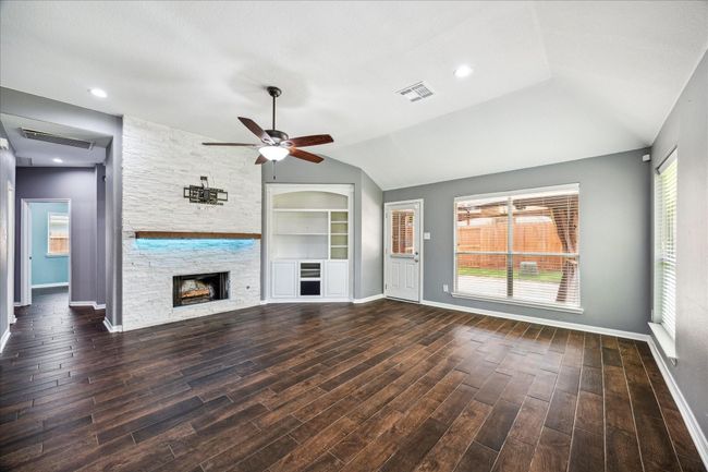 Custom Built-Ins & Fireplace Accent the Living Space | Image 10