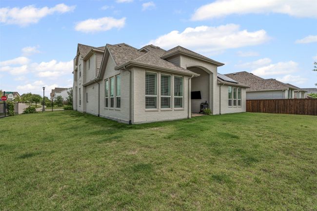 Rear view of property featuring brick siding and a shingled roof | Image 34