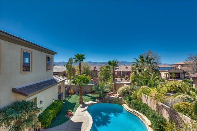 View of pool with a fenced backyard, a residential view, a mountain view, and a fenced in pool | Image 58