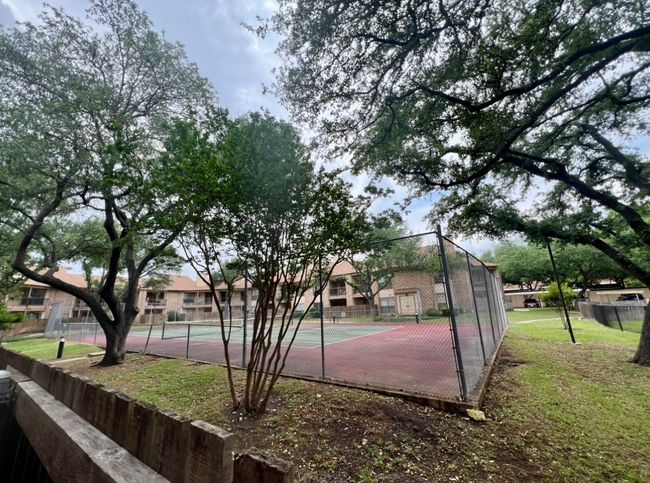 View of basketball court with fence and a tennis court | Image 25