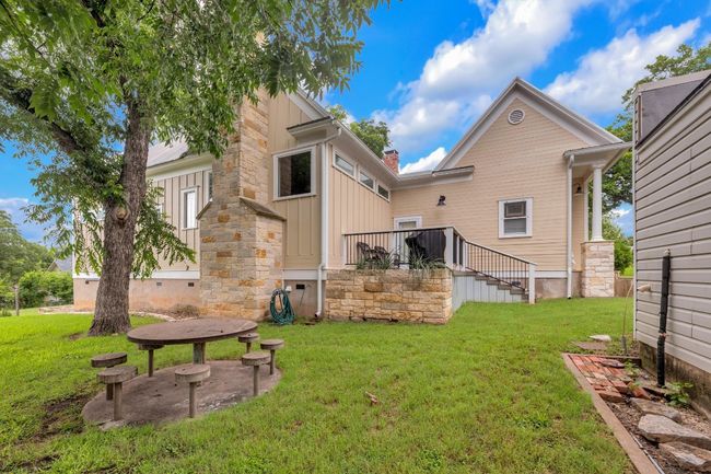 Back of property with a lawn, a chimney, and crawl space | Image 39