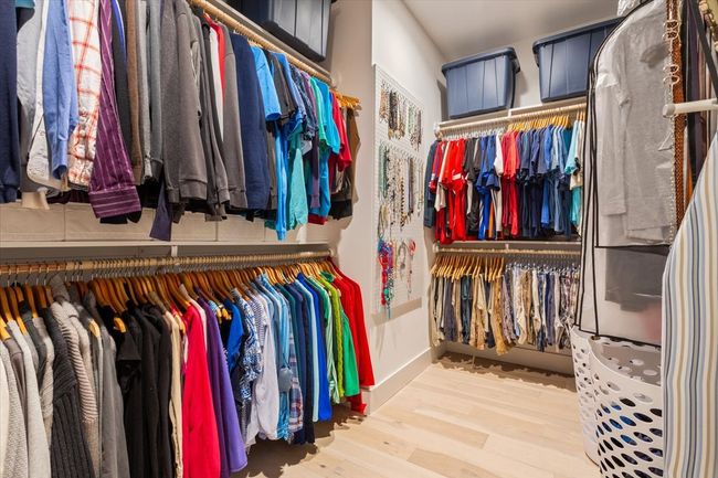 Spacious closet with wood finished floors | Image 24
