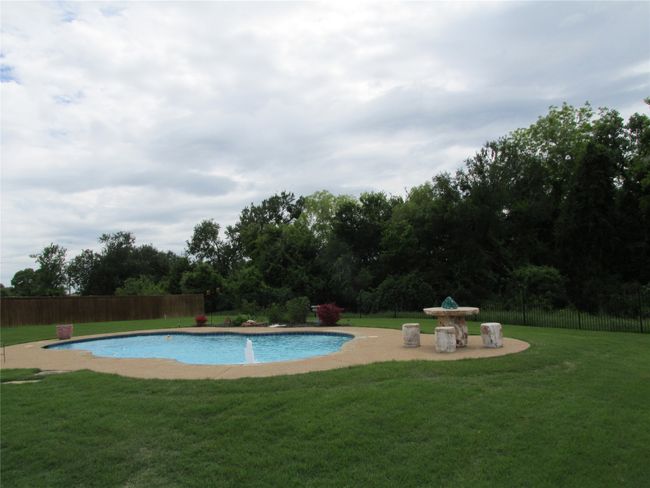 View of pool with a spacious deck area | Image 27