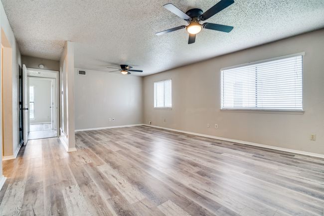 Spare room with ceiling fan, a textured ceiling, and light wood-style floors | Image 18