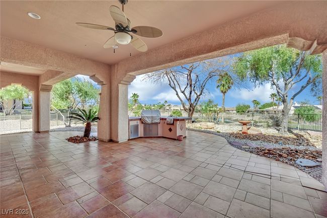 View of patio / terrace featuring ceiling fan, a grill, fence, and an outdoor kitchen | Image 34
