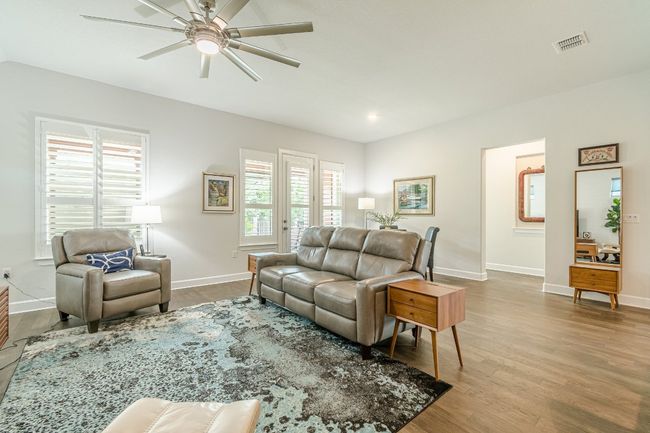 Living room featuring plenty of natural light, ceiling fan, baseboards, wood finished floors, and recessed lighting | Image 19