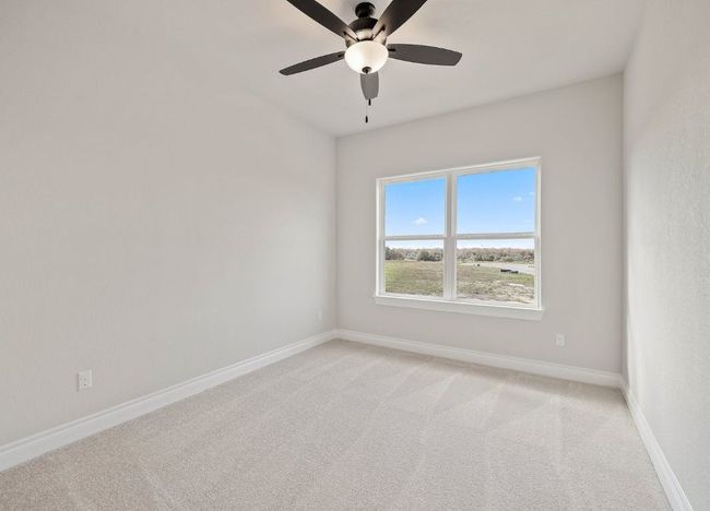 Spare room featuring light colored carpet, ceiling fan, and baseboards | Image 23