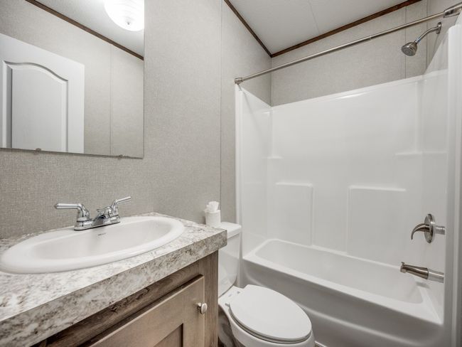 Full bathroom with washtub / shower combination, toilet, vanity, and ornamental molding | Image 17