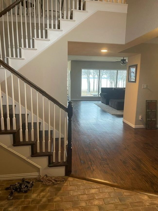 Stairway with a high ceiling, baseboards, and ceiling fan | Image 7