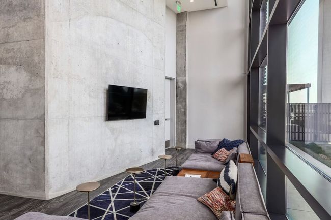 Living area with a towering ceiling | Image 26
