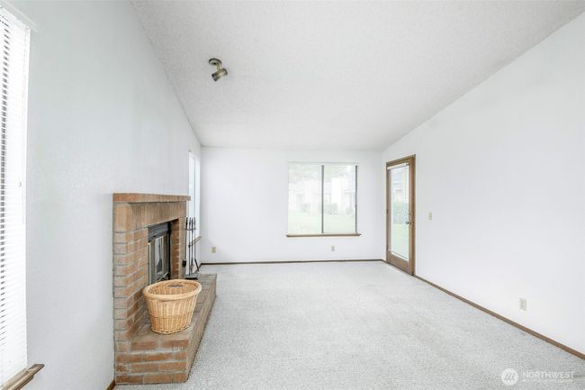 Access to the back patio from the naturally-lit living room | Image 9