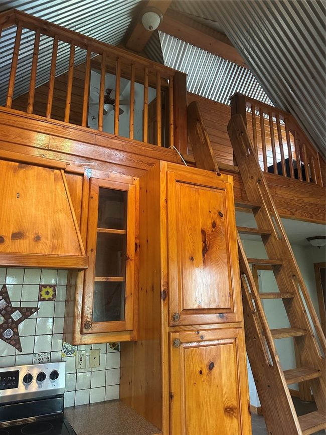 Stairs featuring wood walls | Image 8
