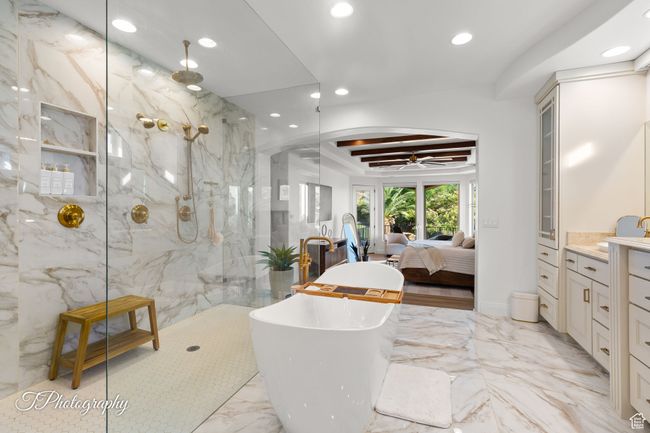 Full bath with recessed lighting, a soaking tub, marble tiled flooring, a marble finish shower, and vanity | Image 31