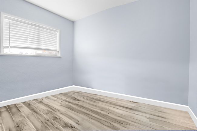 Spare room with baseboards and wood finished floors | Image 20