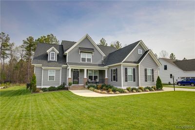 Craftsman inspired home featuring a porch and a front yard | Image 1