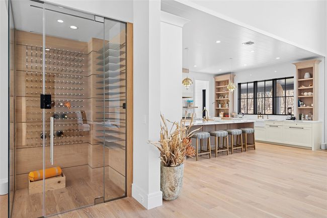 Wine room featuring light wood-style flooring and recessed lighting | Image 36