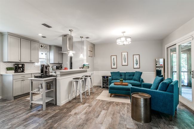 Living area with wood finished floors and recessed lighting | Image 8