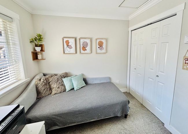 Carpeted bedroom with crown molding and a closet | Image 22