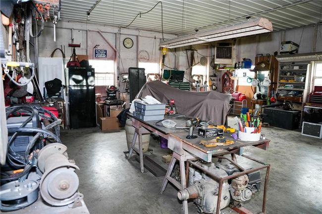 Garage featuring a workshop area | Image 30