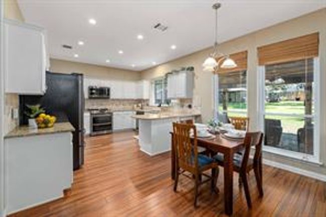 Dining area featuring dark wood-style floors and recessed lighting | Image 20