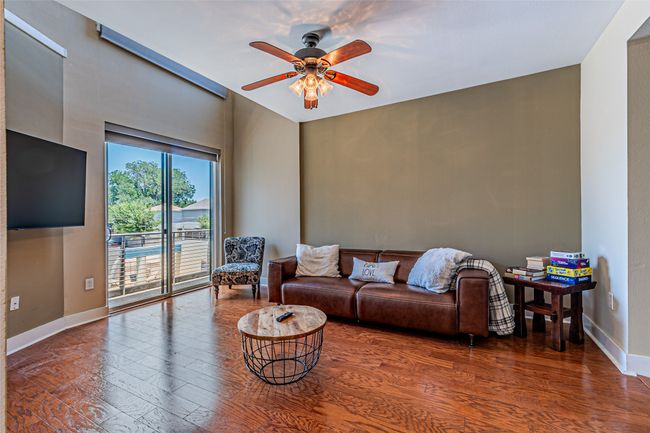 Living area featuring wood finished floors and ceiling fan | Image 4