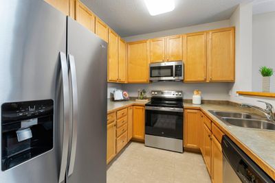 The kitchen has recently been updated with brand new stove and microwave. | Image 2