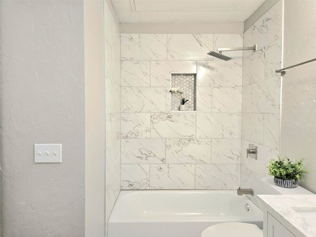 Bathroom featuring tub / shower combination, vanity, and toilet | Image 13