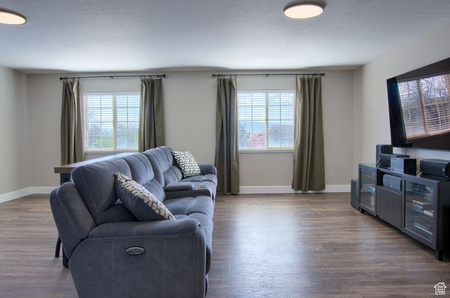 Living room featuring baseboards and dark wood-style floors | Image 34