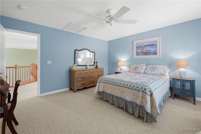 Bedroom featuring carpet floors, a ceiling fan, and attic access | Image 36