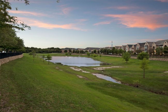 View of property's community featuring a water view, a lawn, and a residential view | Image 35
