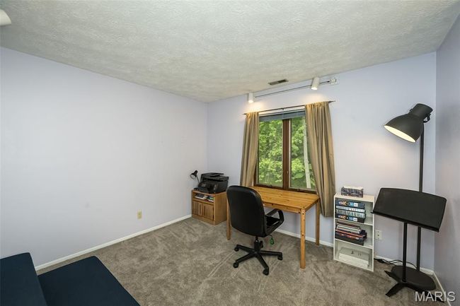 Office space featuring carpet flooring, a textured ceiling, and baseboards | Image 23