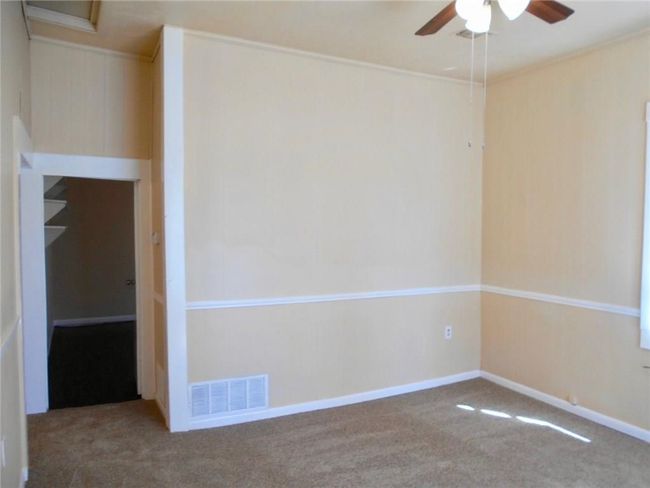 Spare room with a ceiling fan, carpet floors, and crown molding | Image 10