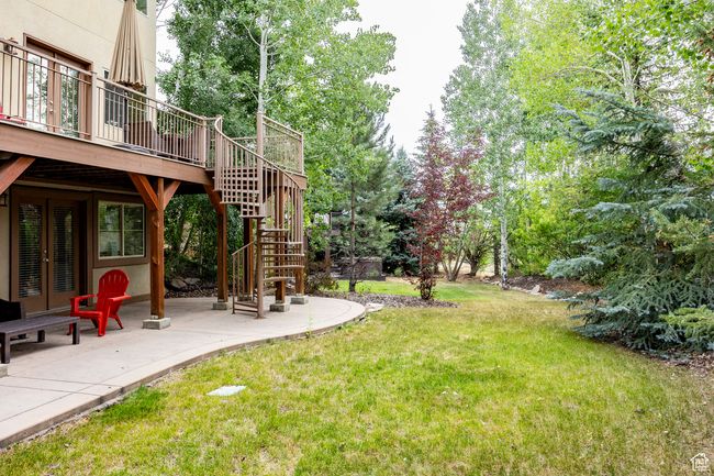 Rear view of property with a patio area, a deck, french doors, and stucco siding | Image 32