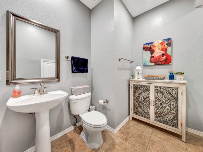 Bathroom with a sink, tile floors, toilet, and baseboards | Image 32