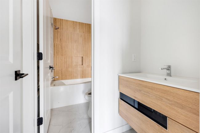 Full bathroom featuring vanity, toilet, and shower / washtub combination | Image 48