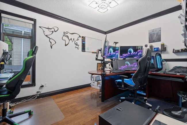 Office featuring ornamental molding, a textured ceiling, and wood finished floors | Image 24