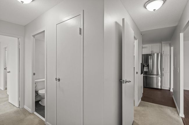 The private primary bedroom is around a corner and down a hall from the main living areas. | Image 14