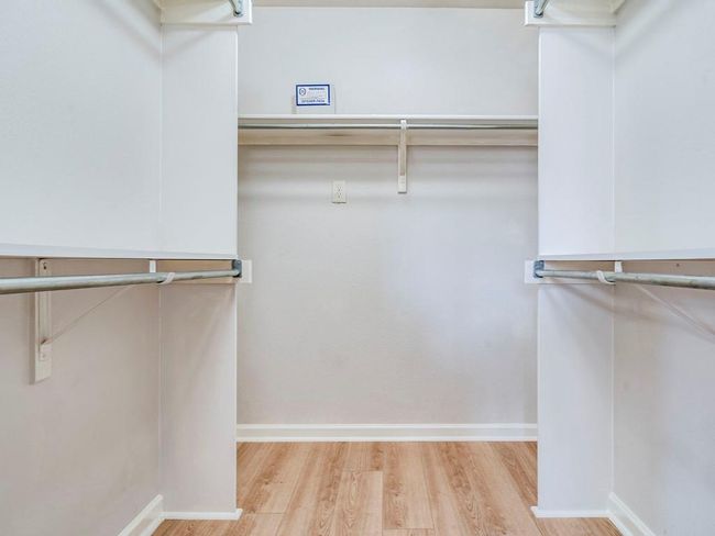 Walk in closet featuring wood finished floors | Image 20