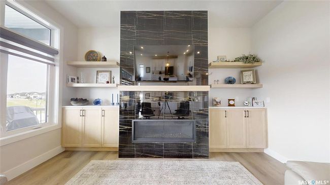 Bar area featuring light wood-type flooring and a tiled fireplace | Image 7