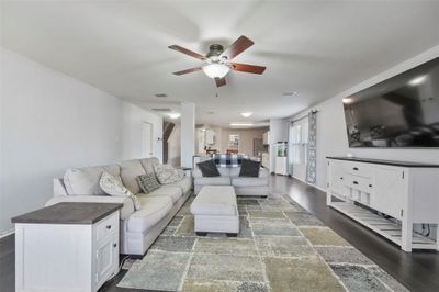 Living room featuring dark hardwood / wood-style flooring and ceiling fan | Image 1