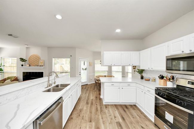 Welcome to the heart of the home—a chef’s dream kitchen equipped with stainless steel appliances, sleek quartz countertops, and stunning cabinetry. It’s designed to inspire your best meals and gatherings. | Image 17