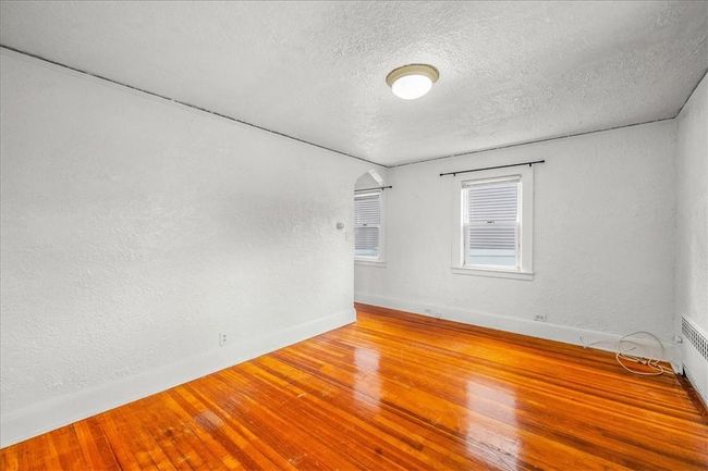 Unfurnished room featuring wood-type flooring and a textured ceiling | Image 19