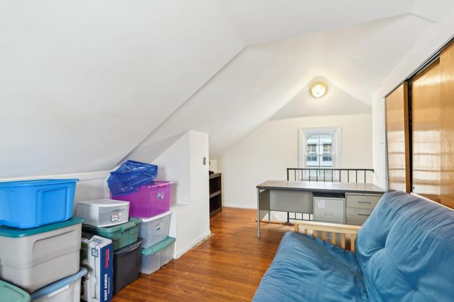 Additional living space featuring dark wood-type flooring and lofted ceiling | Image 24