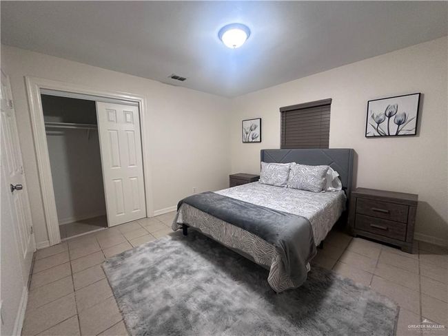Bedroom with light tile patterned floors and a closet | Image 6